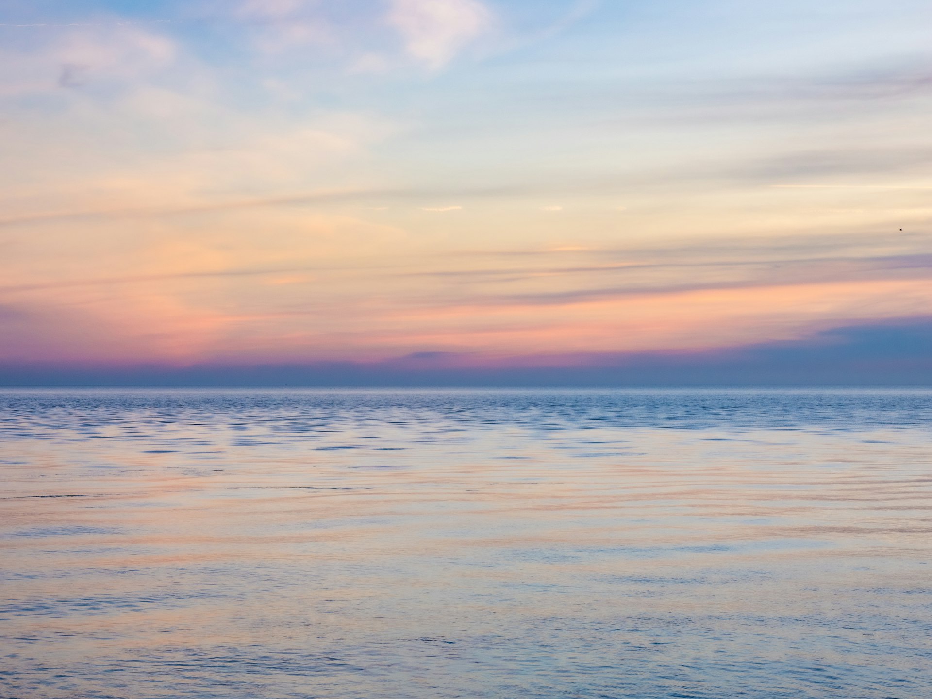 Serene pastel horizon over calm waters
